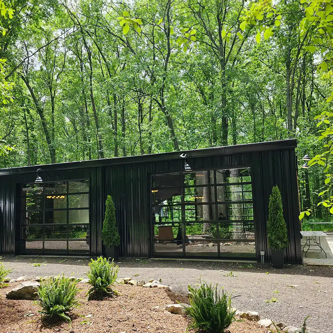 black pre-fabricated steel building with glass doors