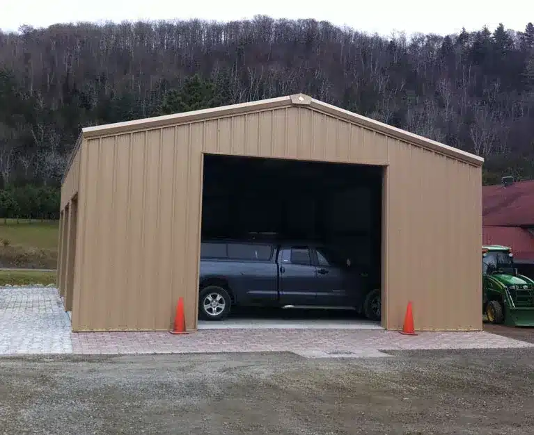 Tan steel garage with large open bay door.