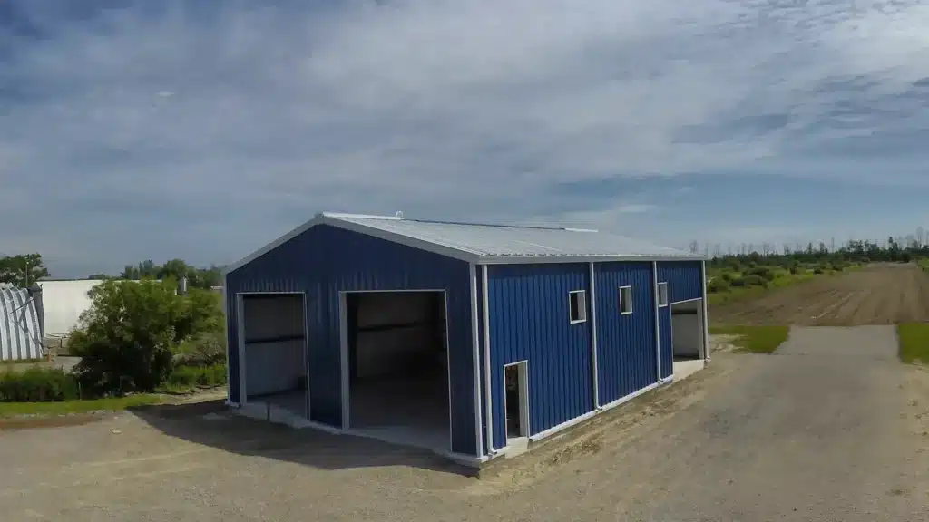 Blue prefab steel garage with open bays Alberta